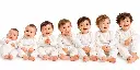 Seven Smiling Toddlers in White.png.webp